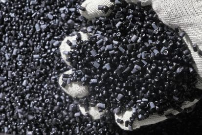 Plastic black gray granulated crumb. Manufacture of plastic water pipes of the factory. Process of making plastic tubes on the machine tool with the use of water and air pressure.